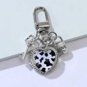 NIP COW PRINT HEART WITH LOCK & KEY BAG CHARM